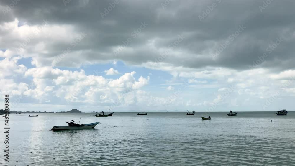 fishing boats on sea in Dark clouds in soft blue sky. dramatic rainstorm cloud above the sea with small speet boats in rainy wet weather. gray cloudscape nature background. traveling in rainy season. fishing boats on sea in Dark clouds in soft blue sky. dramatic rainstorm cloud above the sea with small speet boats in rainy wet weather. gray cloudscape nature background. traveling in rainy season.