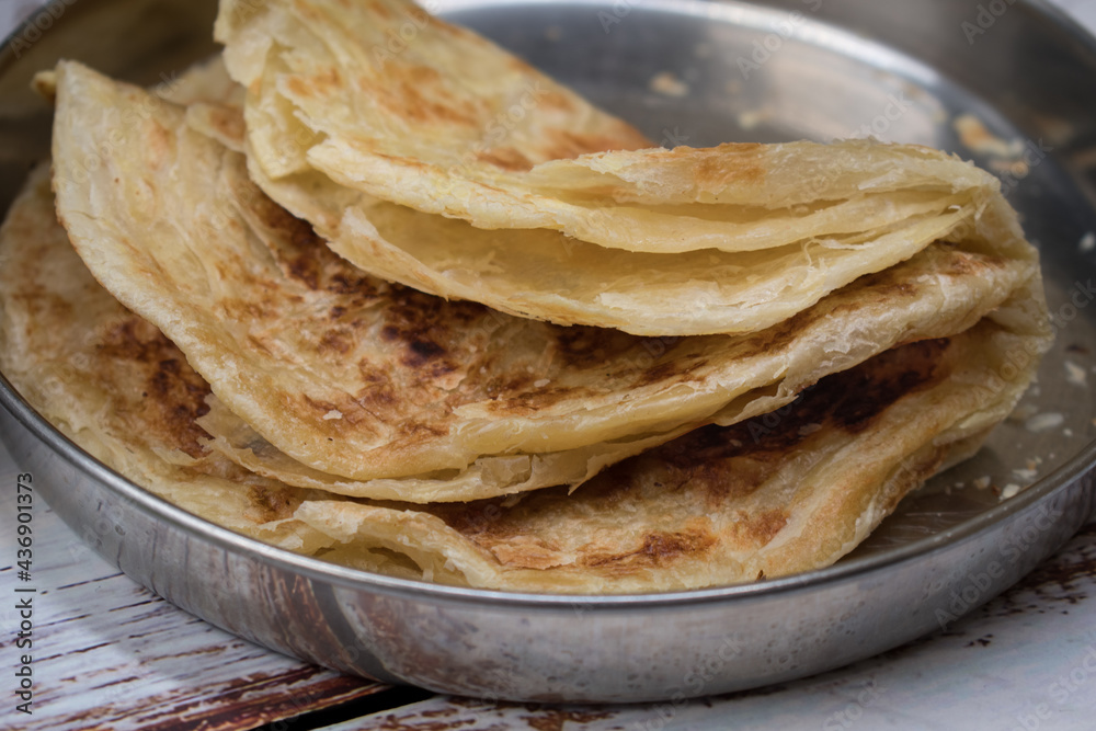Indian paratha flat breads on metal plate Indian paratha flat breads on metal plate