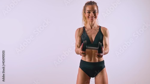 Sporty woman doing exercise with dumbbell
