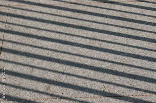 diagonal streaks of light and shadow on a stone floor