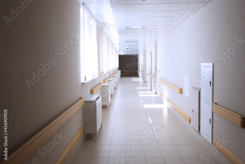 Light empty spacious corridor in medical facility