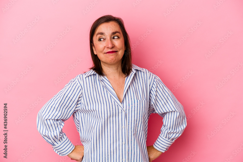 Middle age caucasian woman isolated on pink background dreaming of achieving goals and purposes Middle age caucasian woman isolated on pink background dreaming of achieving goals and purposes