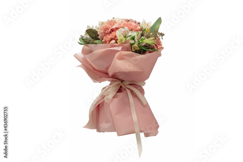 Bouquet of soft pink flowers in pink wrapping paper.