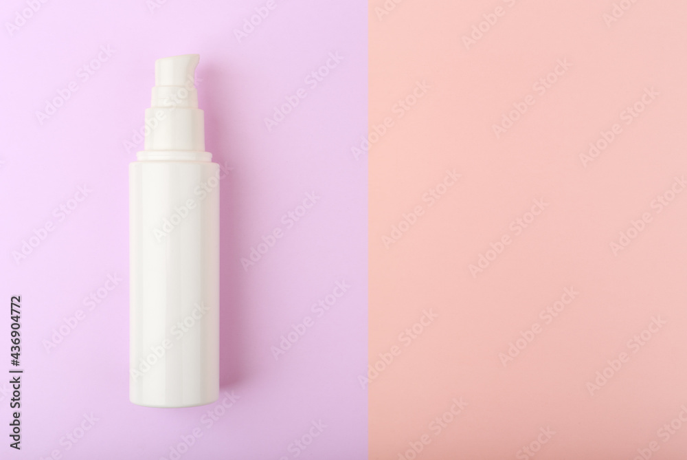 Creative flat lay with face cream in white glossy tube against purple and pink background with copy space. Concept of moisturizing cream or lotion for face or hands Creative flat lay with face cream in white glossy tube against purple and pink background with copy space. Concept of moisturizing cream or lotion for face or hands
