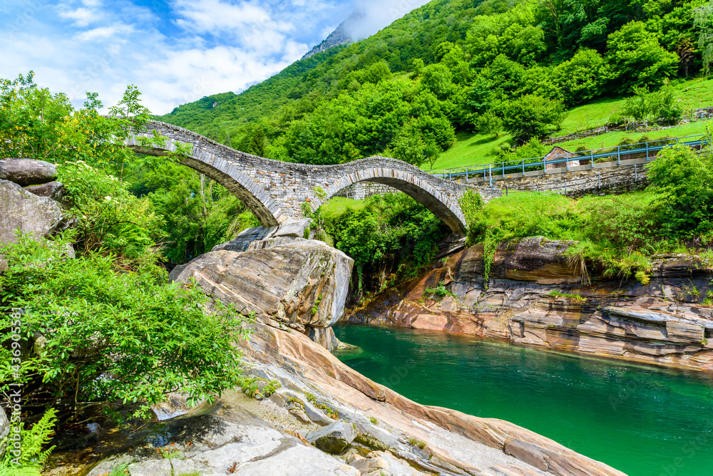 View of Bridge Ponte dei Salti to Verzasca River at Lavertezzo - clear and turquoise water stream and rocks in Ticino - Valle Verzasca - Valley in Tessin - Travel destination in Switzerland View of Bridge Ponte dei Salti to Verzasca River at Lavertezzo - clear and turquoise water stream and rocks in Ticino - Valle Verzasca - Valley in Tessin - Travel destination in Switzerland