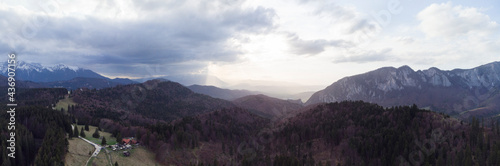 Aerial view of Poiana Secuilor cabin with Bucegi mountains in the background.