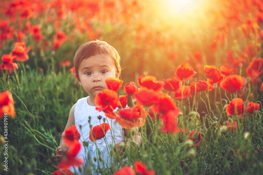 Emotional child outdoor portrait of nice little girl in white dress in poppy field. Emotional child outdoor portrait of nice little girl in white dress in poppy field.