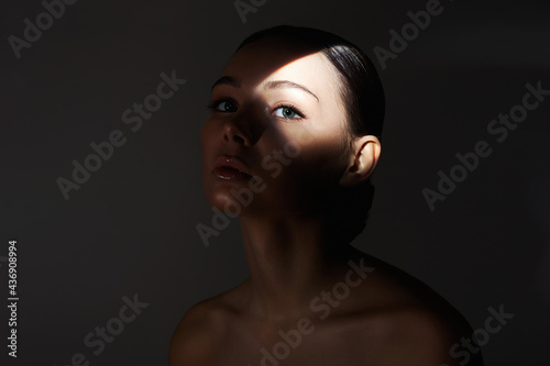 portrait of young woman with shadow on her face