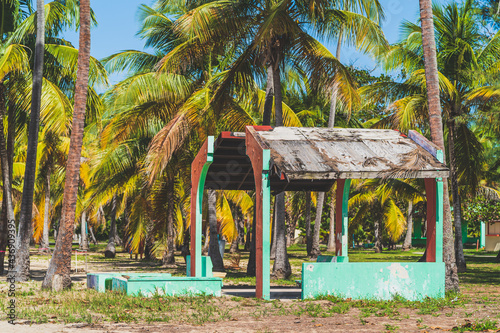 Depilated building damaged from hurricane on tropical beach park photo