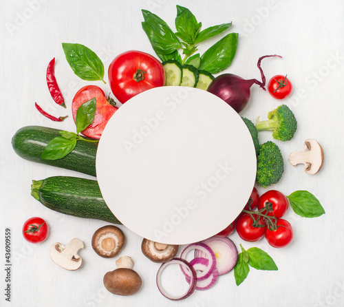 Creative layout made of various vegetables mushrooms and herbs with white round paper card. Flat lay. Healthy food concept.