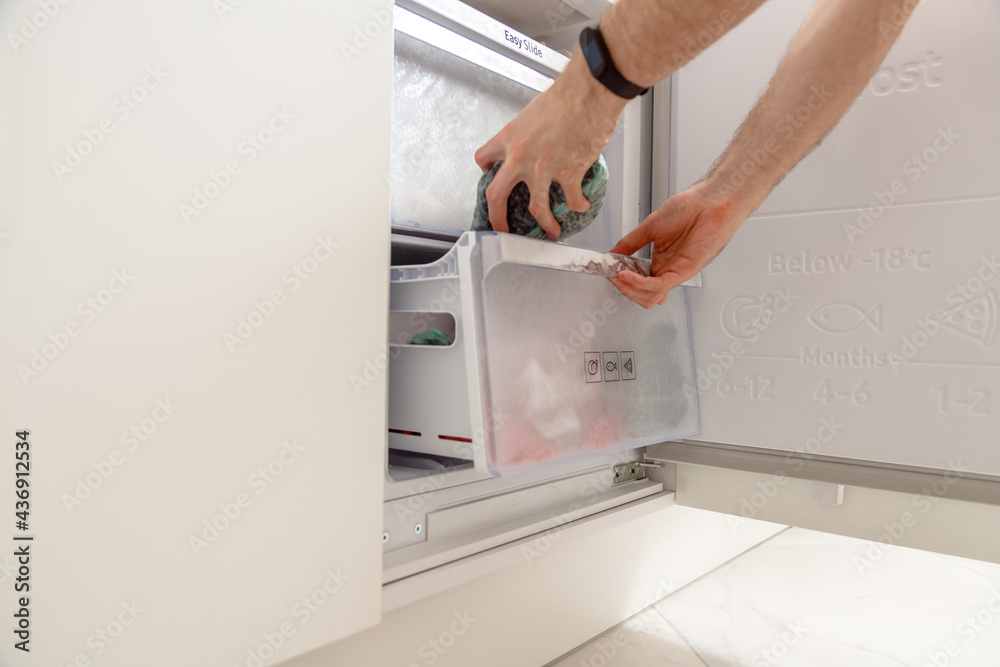 Different frozen berries in plastic bags in refrigerator. Food storage. Frozen food. Hand opening freezer. Plastic packaging. Different frozen berries in plastic bags in refrigerator. Food storage. Frozen food. Hand opening freezer. Plastic packaging.