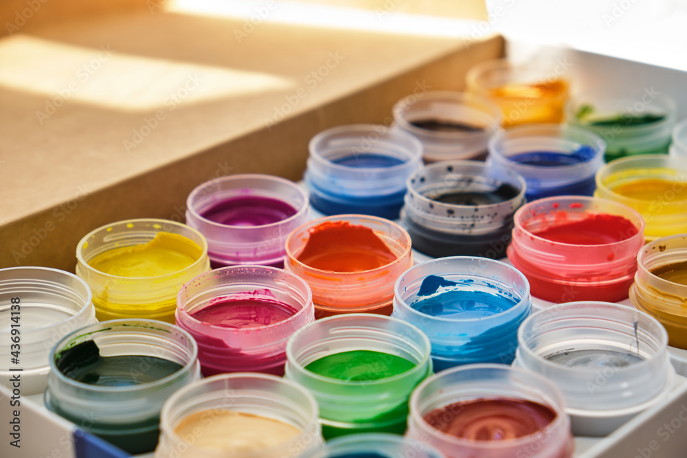 Closeup of messy, used water-color paint-box and paint brush. Closeup of messy, used water-color paint-box and paint brush.