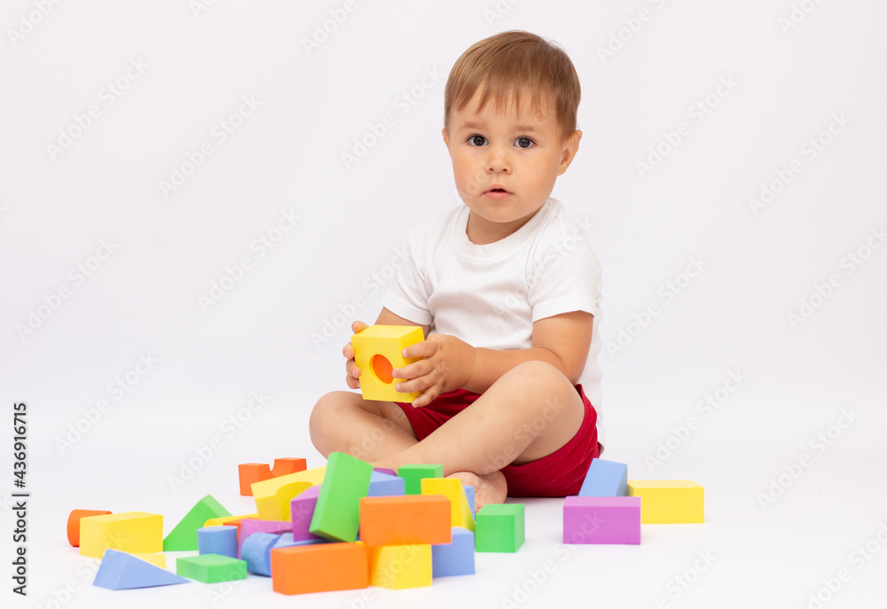 cheerful kid boy with construction set over white background cheerful kid boy with construction set over white background