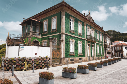 Green house with a metal gate in Vila Nova de Cerveira, Portugal photo