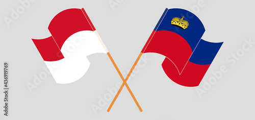 Crossed and waving flags of Indonesia and Liechtenstein
