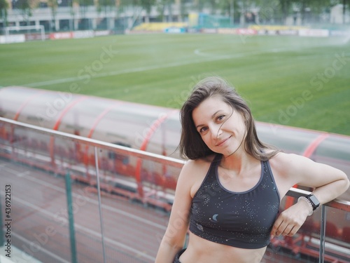 young woman goes in for sports in the stadium  running  jumping rope  warm-up and stretching