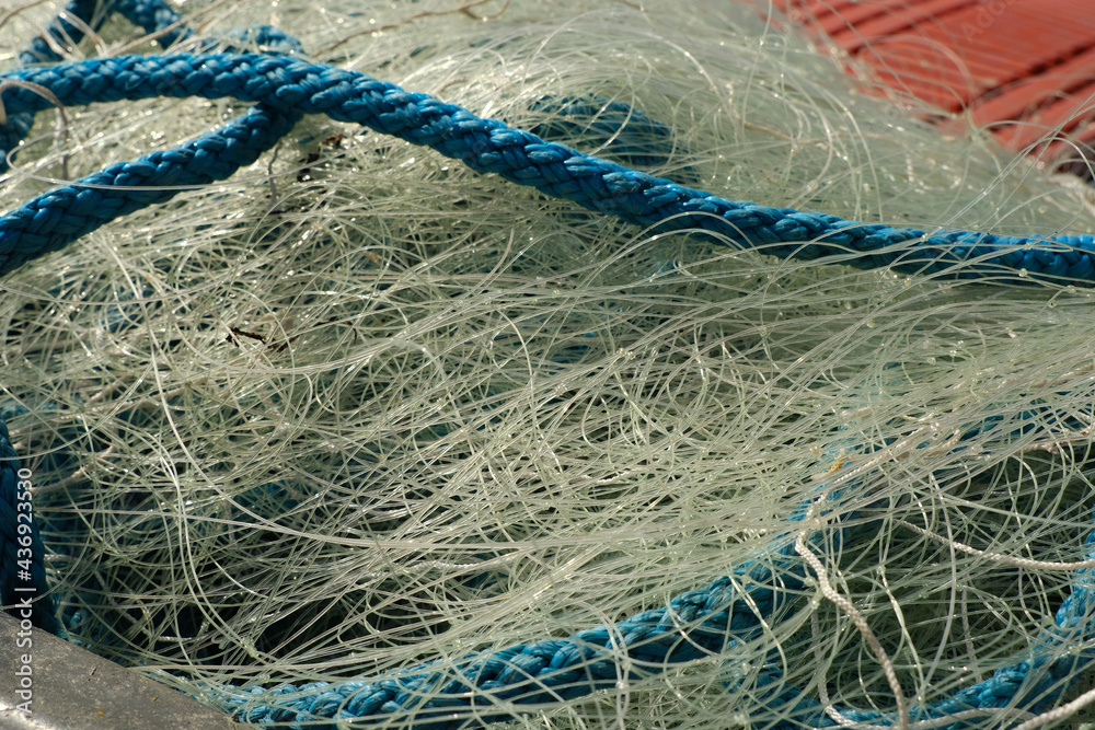 A pile of fishing rope and nylon netting. Close up view filling the frame. A pile of fishing rope and nylon netting. Close up view filling the frame.