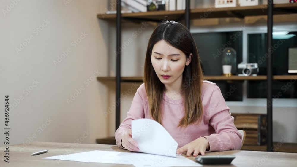 Slow motion frustrated Asian woman looking at the paper bills upset throwing crumpled paper away. mental problems, failure reaction Slow motion frustrated Asian woman looking at the paper bills upset throwing crumpled paper away. mental problems, failure reaction
