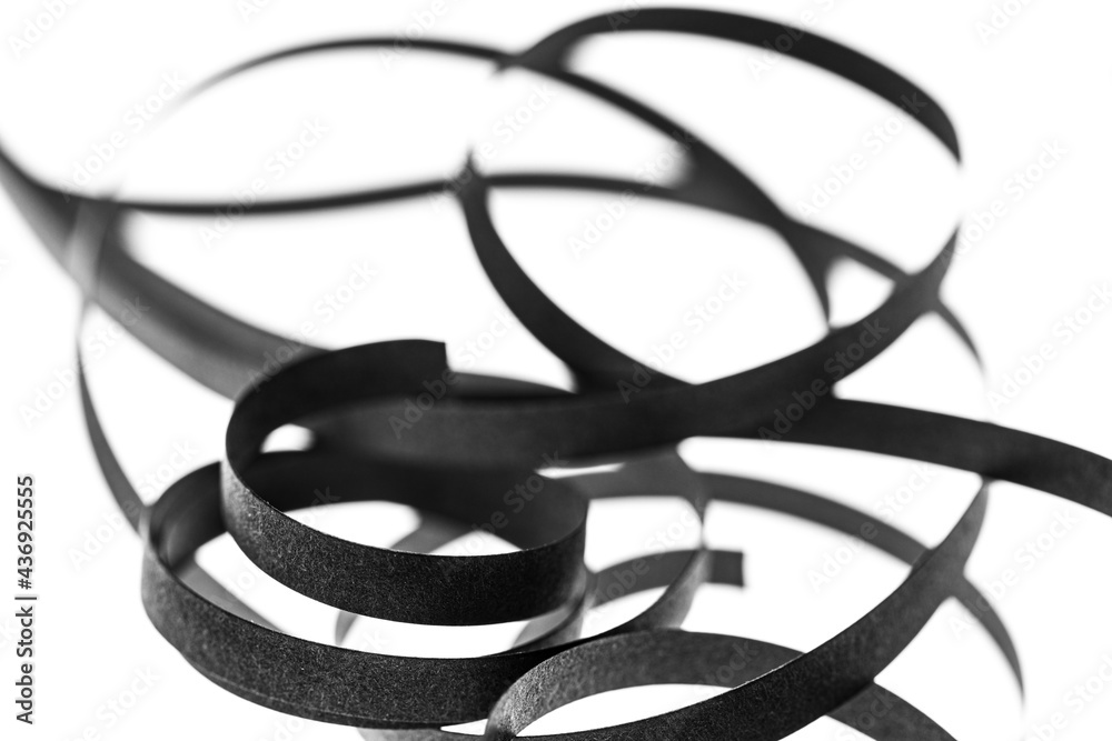 A curled black paper ribbons. Abstract artistic patterns. Design concept. Ready solutions for interior design office. Macro lens close up shot 1:1. Monochrome image. A curled black paper ribbons. Abstract artistic patterns. Design concept. Ready solutions for interior design office. Macro lens close up shot 1:1. Monochrome image.