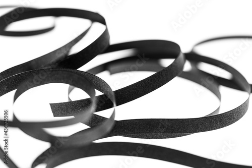 A curled black paper ribbons. Abstract artistic patterns. Design concept. Ready solutions for interior design office. Macro lens close up shot 1:1. Monochrome image.