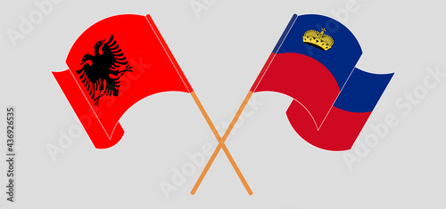 Crossed and waving flags of Albania and Liechtenstein