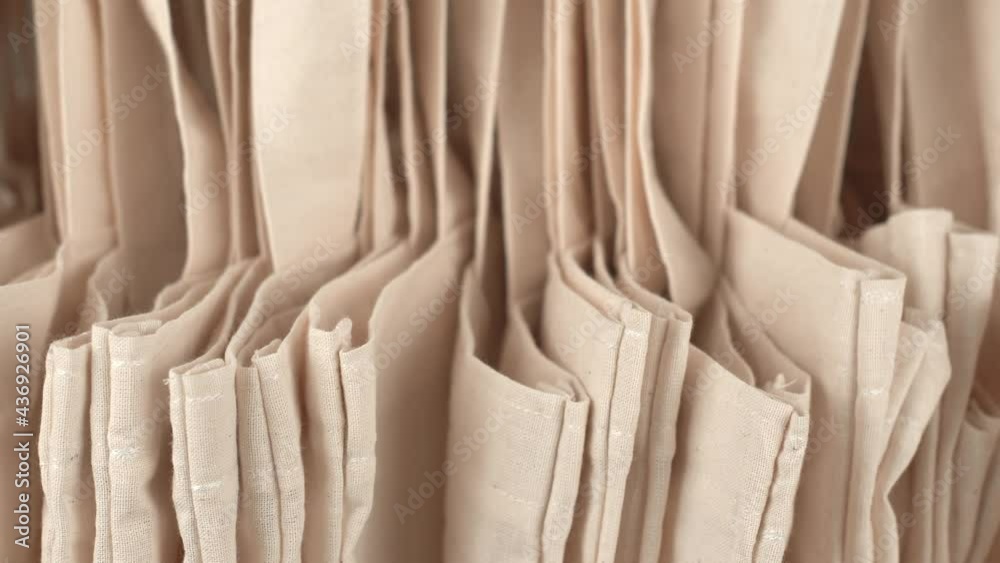 Panning footage of many beige eco bags background