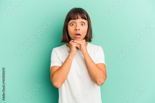 Young mixed race woman isolated on blue background joyful laughing a lot. Happiness concept.