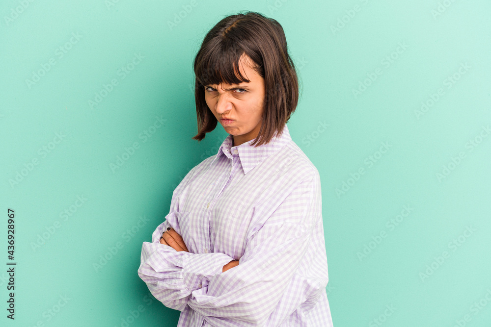 Young mixed race woman isolated on blue background showing a timeout gesture. Young mixed race woman isolated on blue background showing a timeout gesture.