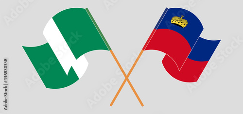 Crossed and waving flags of Nigeria and Liechtenstein