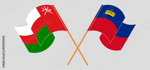 Crossed and waving flags of Oman and Liechtenstein