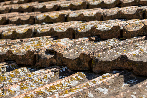 The old ceramic shingles on the roof closeup