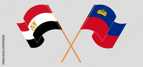 Crossed and waving flags of Egypt and Liechtenstein