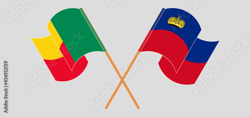 Crossed and waving flags of Benin and Liechtenstein
