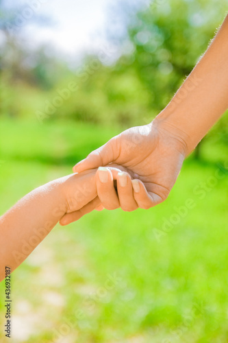 hands Happy parents and child outdoors in the park