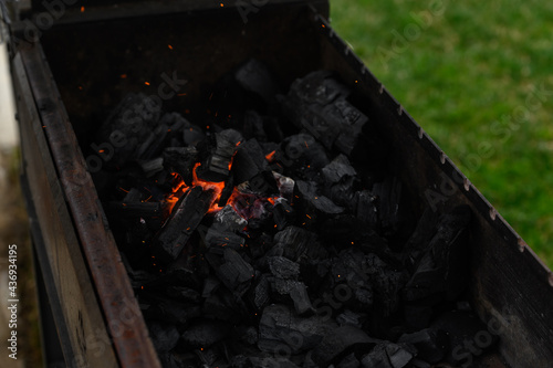 the process of lighting charcoal in the grill