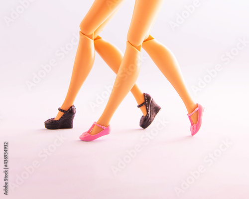 Female legs in shoes, walking together. Minimal girls night out concept.
