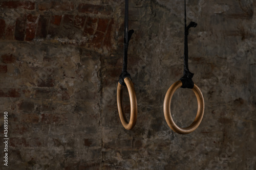 gymnastic rings and bars on the background of an old brick wall photo