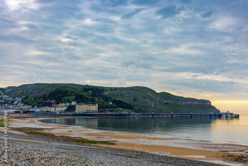 The sun starts to set on Llandudno pier and promenade photo