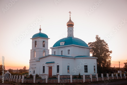 Orthodox temple with domes at sunset.