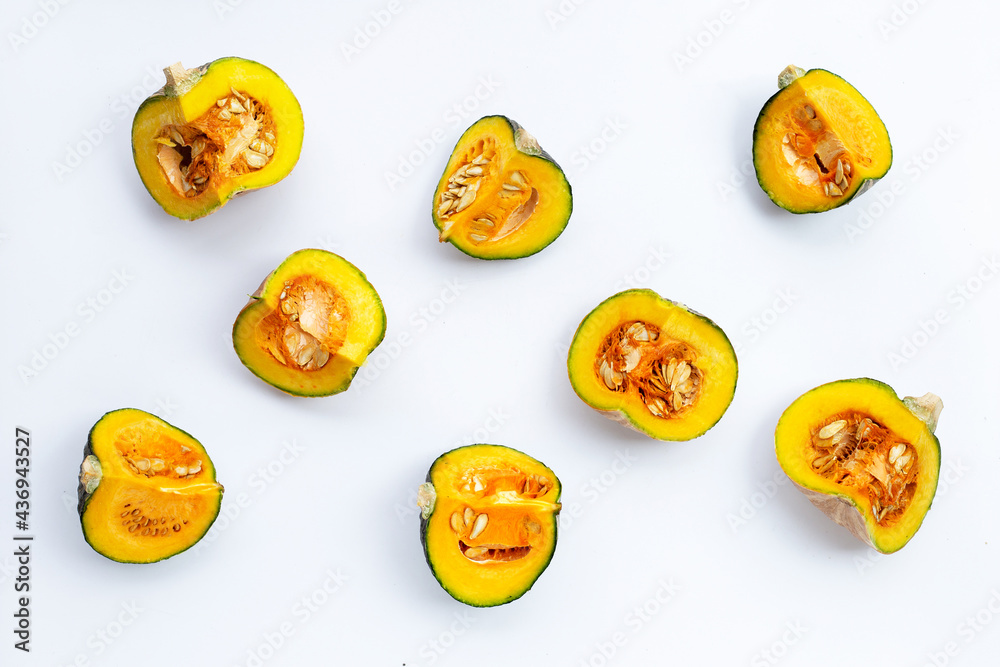 Fototapeta premium Green pumpkin pieces on white.