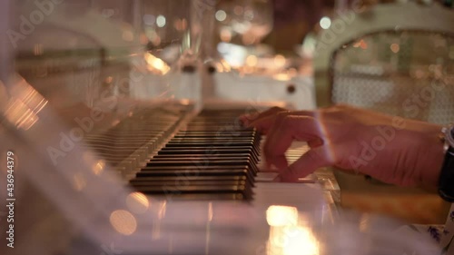 Female hands play the piano in a restaurant. photo