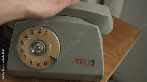 dialing a number on an old bakelite landline phone photo