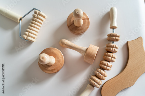 Wood massage maderotherapy madero therapy wooden rolling pin or battledore tools for anti cellulite treatment to stimulate the lymphatic system and improve circulation concept photo