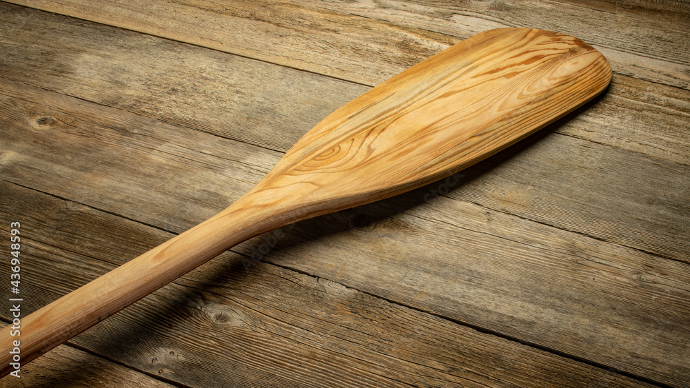 blade of wooden canoe paddle against rustic weathered wood - obrazy, fototapety, plakaty 