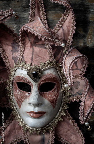 Venetian carnival mask fixed in wood. Luxury, mystery and glamor in a typical Venetian festivity.