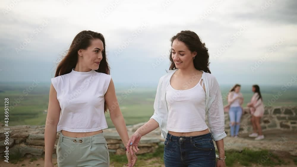 Happy young attractive girl friends having fun. Lesbian couple spending time together in sunny day. LGBTQ concept. Travelling couple doing sightseeing. Diverse love pride. Happy young attractive girl friends having fun. Lesbian couple spending time together in sunny day. LGBTQ concept. Travelling couple doing sightseeing. Diverse love pride.