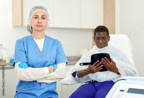 Portrait of cosmetician woman preparing to medicine procedure with man in clinic of esthetic cosmetology