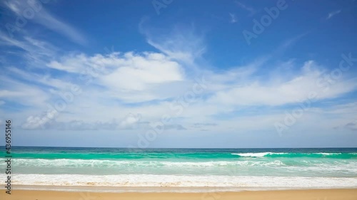 Phuket tropical beach in Thailand Wave on sand beach and beautiful sky Summer season on sunny day horizon and cloud visible Sea with turquoise water waves gushed towards shore and bubble covered sand