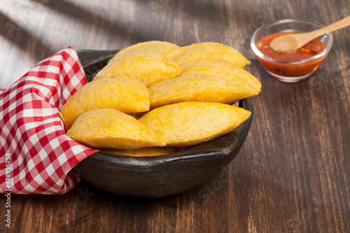 Tasty empanadas - Colombian cuisine; photo on wooden background
