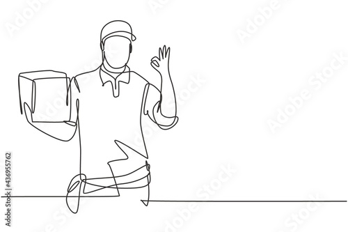 Single continuous line drawing delivery man with gesture okay, carrying the package box to be delivered to customers with the best service. Dynamic one line draw graphic design vector illustration